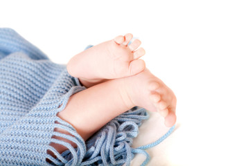 Baby feet covered in blue wrap isolated background