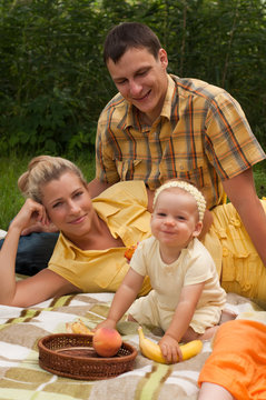 Happy family picnicking outdoors