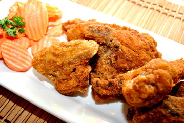 Resturant Plate of Fried Chicken with a Side of Carrots