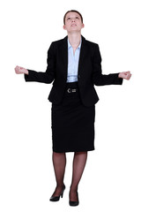 young businesswoman looking upwards tight-fisted