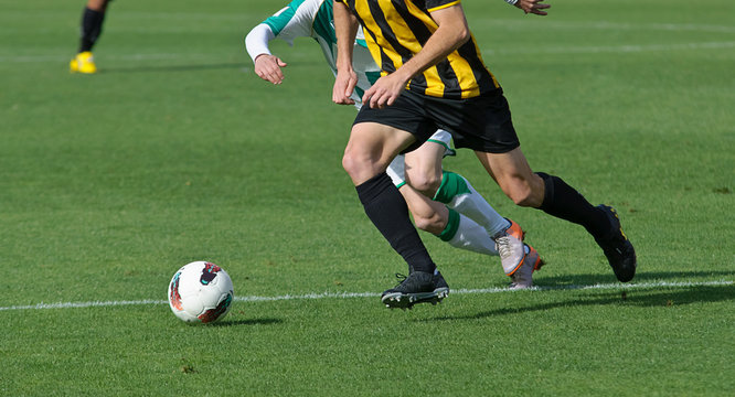 Jugadores de fútbol jugando el balón