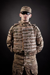 Military man on a black background
