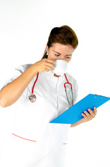 Medical female doctor with stethoscope and clipboard drinking co