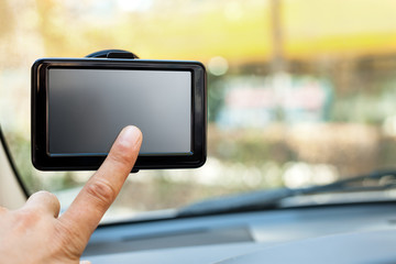 finger pointing at car GPS