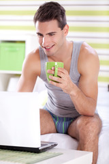 Young men in morning with laptop and coffee