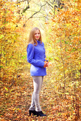 Portrait of a beautiful girl in autumn forest