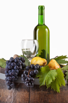 Bottle of white wine and various autumn fruits
