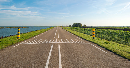 Road on a dike along a lake