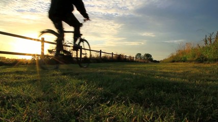 Bicyclers during sunset