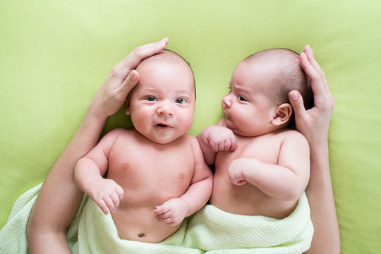 Loving Mother Hands Embrace Twins Babies