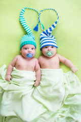two twins brothers babies weared in hats © Oksana Kuzmina