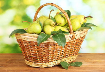 Juicy flavorful pears in basket of nature background