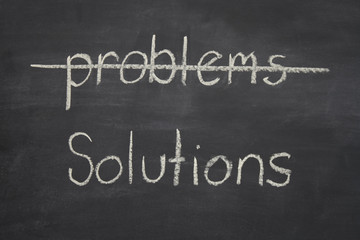 Obraz premium problems crossed out and solutions written underneath on a black