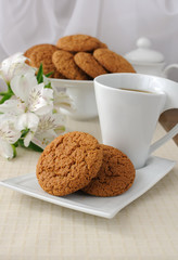 A cup of tea with oatmeal cookies