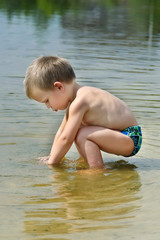 Child on the bank of the river