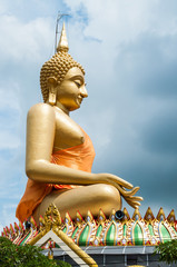Big Buddha image with cloudy sky