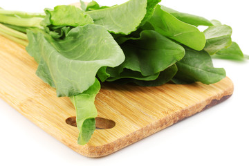 Fresh sorrel on wooden board isolated on white