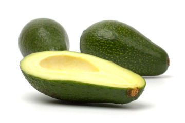 Ripe cut avocado isolated on white background