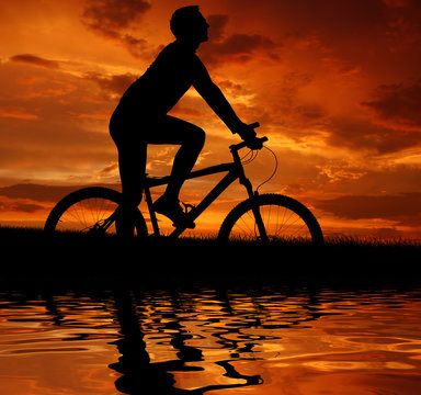 silhouette cyclist in the sunset