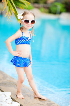 Little girl near swimming pool