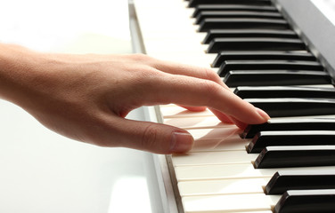 hand of woman playing synthesizer