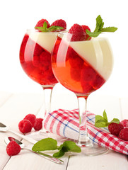 fruit jelly with raspberries in glasses on wooden table
