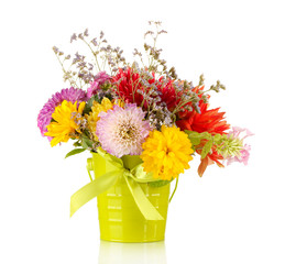 Fototapeta premium Bright green bucket with flowers isolated on white