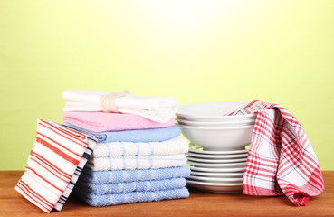 kitchen towels with dishes on green background close-up