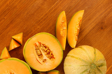 cut melon on wooden background close-up