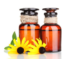 medicine bottles and flowers isolated on white