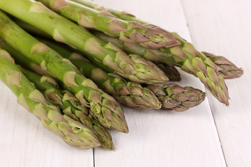 Fresh asparagus on white wooden table background