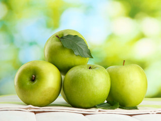Ripe green apples with leaves ,