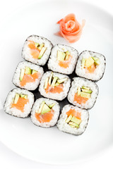 Sushi rolls with sashimi, isolated on white. Top view