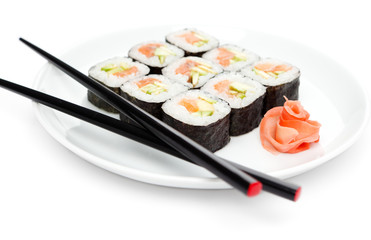 Maki sushi rolls on the plate with chopsticks, isolated on white
