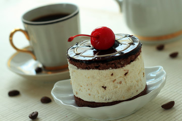 Pastry with a cherry on a dish