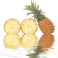 Pineapple and its slices with reflection