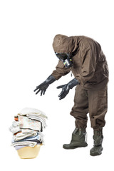 Man in Hazard Suit looking at dirty laundry