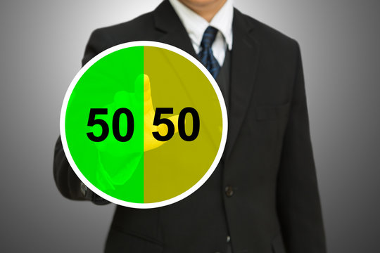 Business man touching on Pie chart with fifty-fifty percent. 50