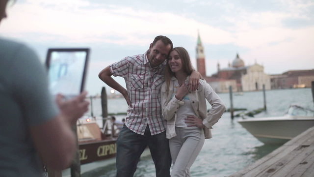 Tourist couple looking at the map in Venice 
