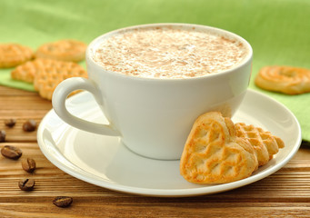 Cappuccino and cookies on a brown table