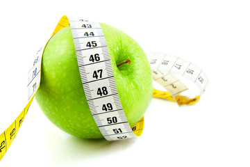 Fresh green apple with measure tape
