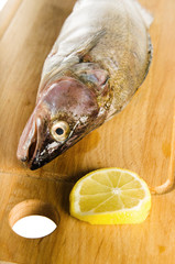Pike perch on a wooden kitchen board, it is isolated on white