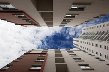 looking up at tall condominiums from base