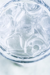 Glass of fresh cold water with ice cubes