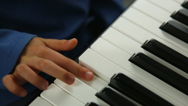Child learning the piano