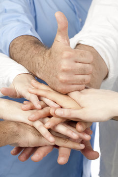 diverse group of peoples hands together