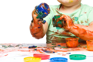 Child is grabbing some paint using fingers