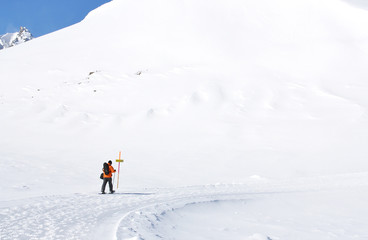 Fototapeta na wymiar Hiking in snowshoes along the mountain track