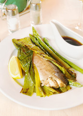 Grilled fish with asparagus on the plate