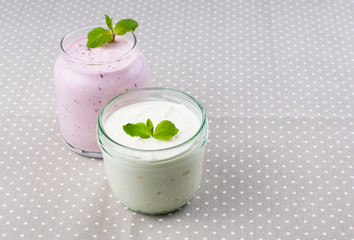 Obraz na płótnie Canvas Two jars of yogurt cream